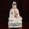 Xiangyun Songzi Guanyin with a boy on her lap, ivory robes and gold-tone cloud-pattern base
