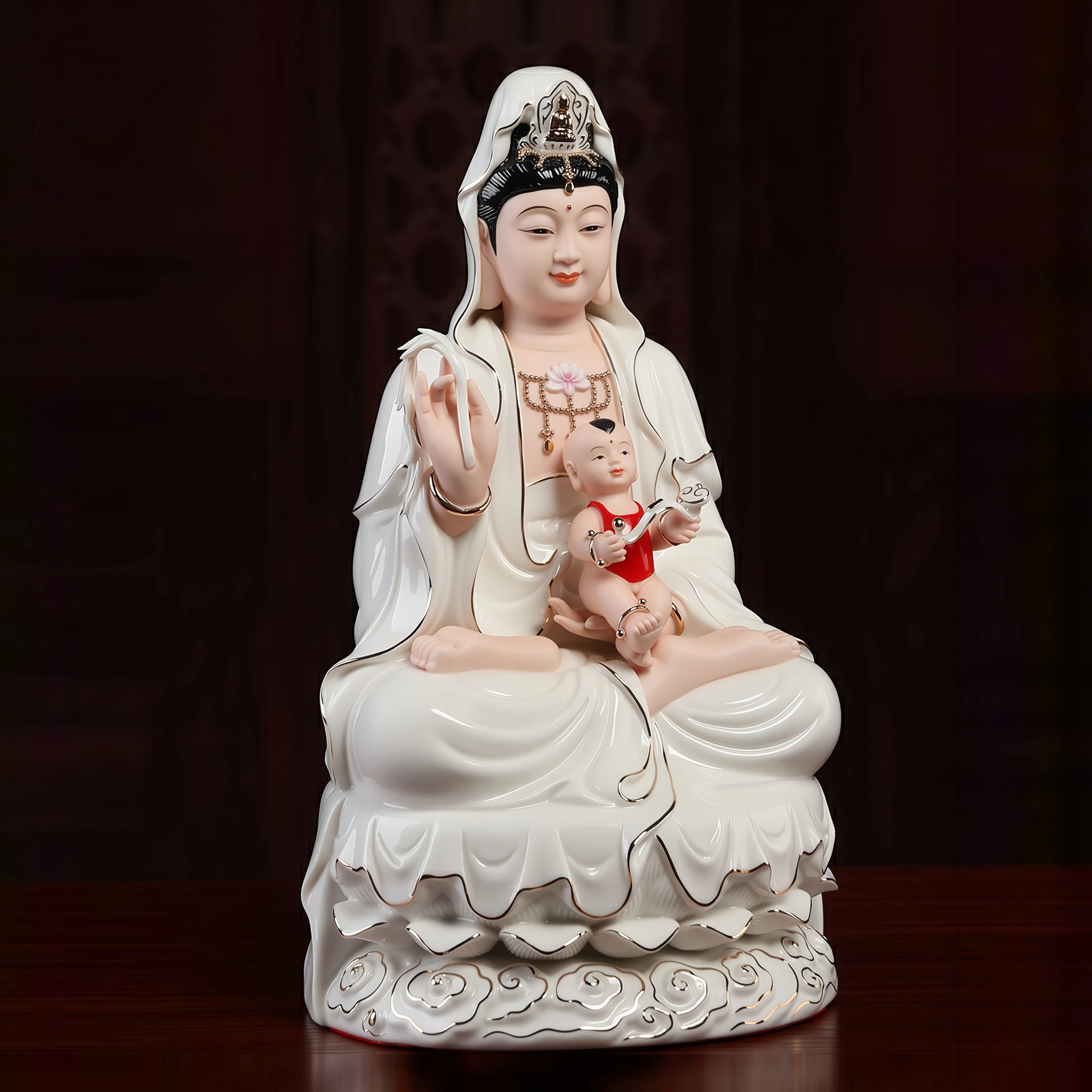 Xiangyun Songzi Guanyin with a boy on her lap, ivory robes and gold-tone cloud-pattern base