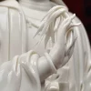 Raised hand of the Yangzhi Guanyin statue holding the narrow leaves of a willow sprig