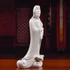 Side view of the standing dripping water Guanyin, showing curved robes and the projecting lotus leaf