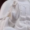 Raised hand and curved held detail on the white porcelain Zuolian Guanyin