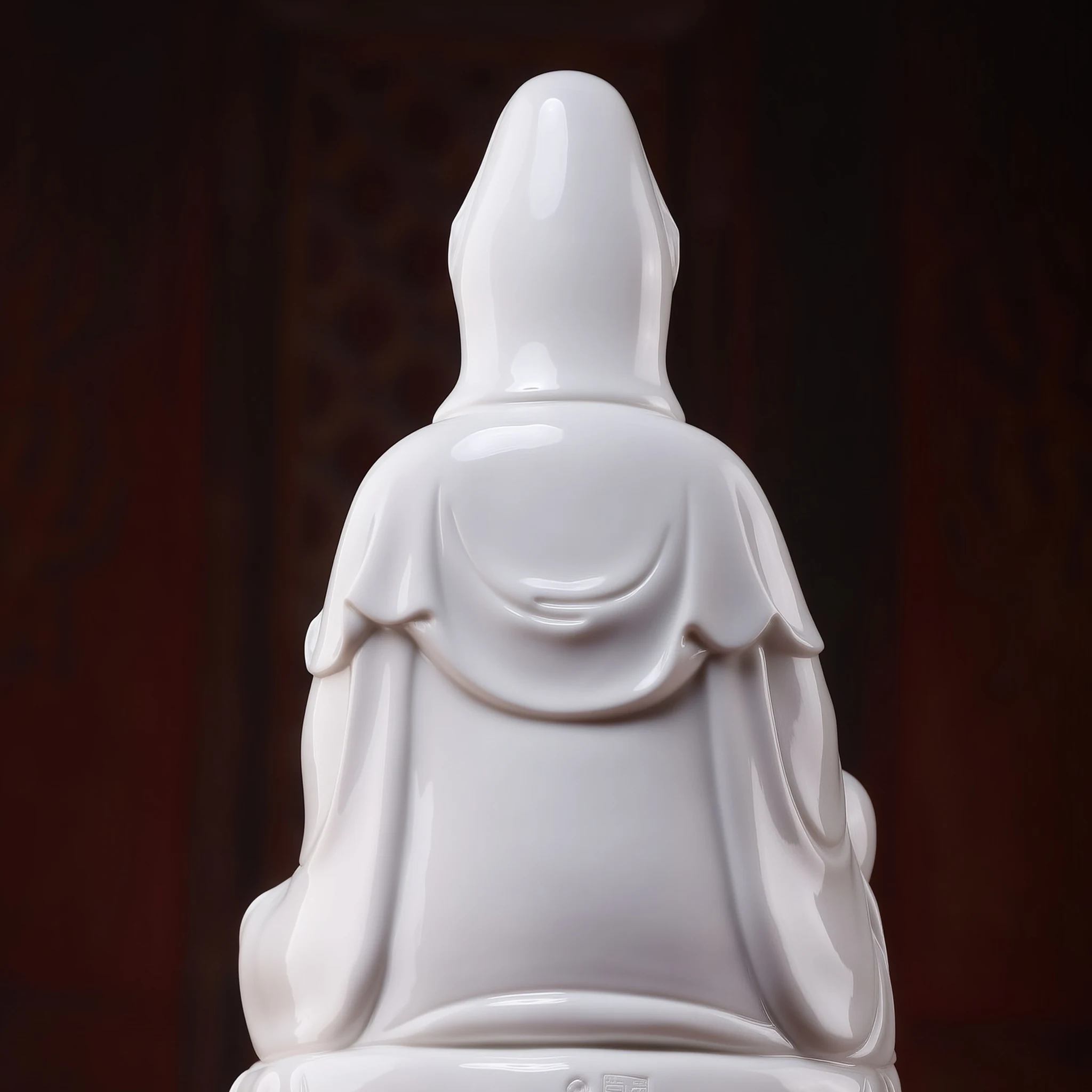 Rear detail of the white Zuolian Guanyin showing the hood and layered robe folds