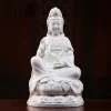White porcelain Zuolian Guanyin with a slender vase, one knee raised and a rounded lotus seat