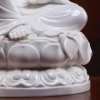 Exposed foot, flowing robe and rounded lotus petals on the white Zuolian Kuan Yin